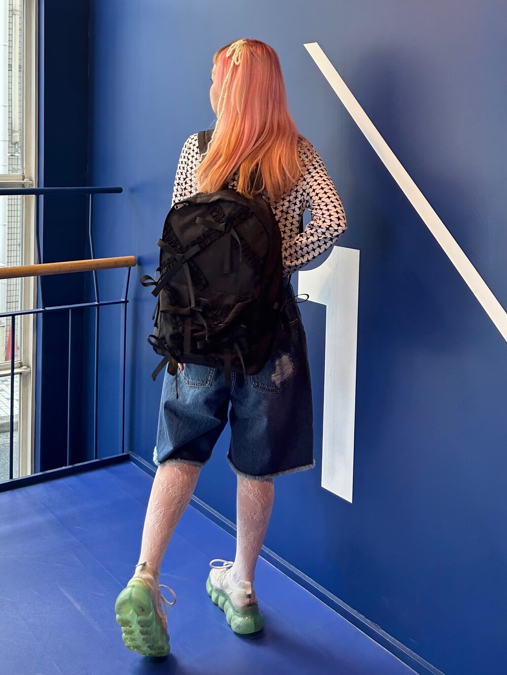 ホワイト系のその他トップス、ブルー系のデニムパンツ、ブラック系のバックパック/リュックを着用したレディースの夏コーディネートの4枚目の写真