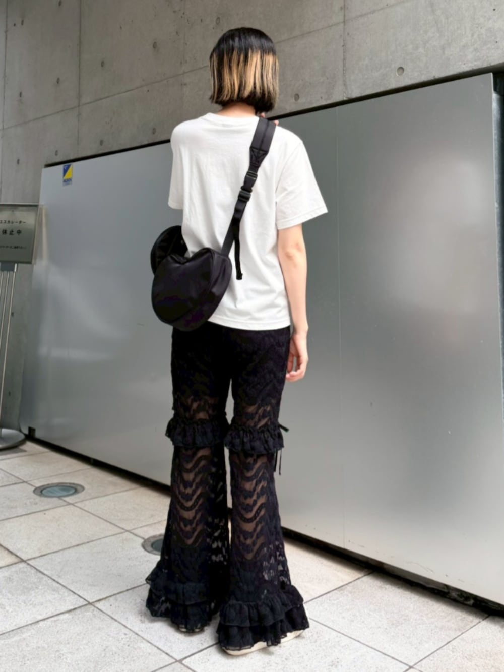ブラック系のその他パンツ、ブラック系のショルダーバッグ、ホワイト系のTシャツ/カットソーを着用したレディースの夏コーディネートの2枚目の写真