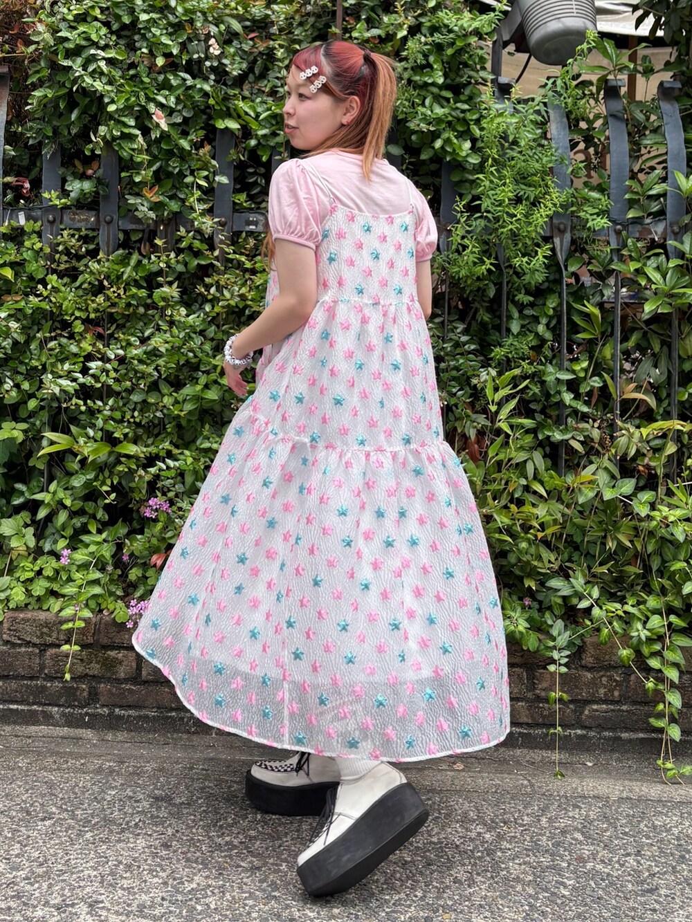 ピンク系のワンピース、ピンク系のTシャツ/カットソー、ブラック系のショルダーバッグを着用したレディースの夏コーディネートの4枚目の写真