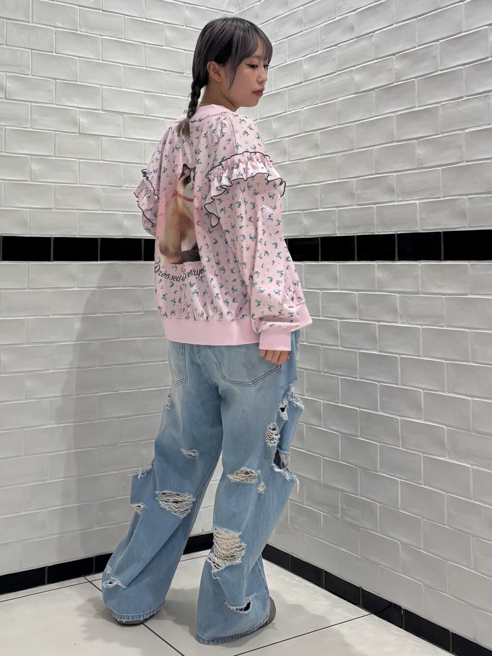 ブルー系のデニムパンツ、ホワイト系のスカート、ホワイト系のTシャツ/カットソーを着用したレディースの春コーディネートの3枚目の写真