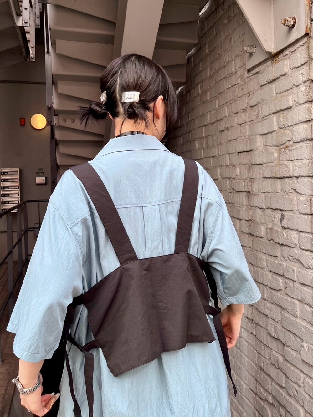 ブラック系のワンピース、ブラック系のベスト、ブルー系のシャツ/ブラウスを着用したレディースの夏コーディネートの5枚目の写真