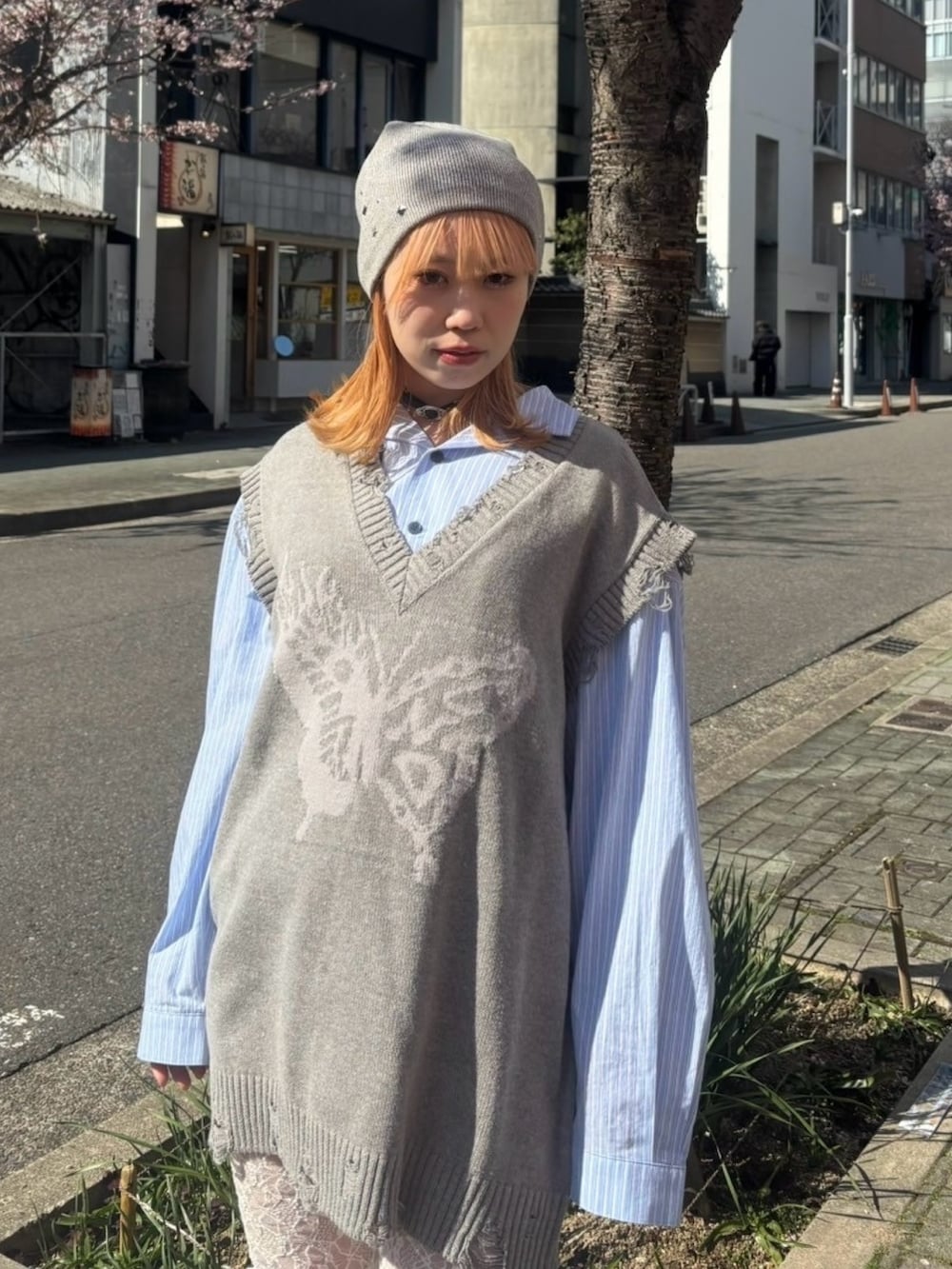 グレー系のベスト、ブルー系のシャツ/ブラウス、ホワイト系のその他パンツを着用したレディースの春コーディネートの5枚目の写真