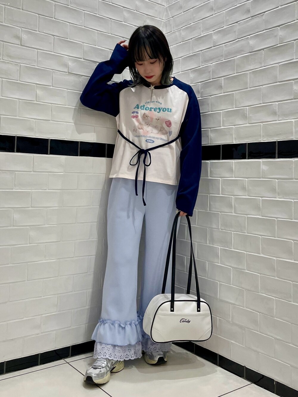 ピンク系のTシャツ/カットソー、ブルー系のその他パンツ、ホワイト系のボストンバッグを着用したレディースの冬コーディネートの2枚目の写真