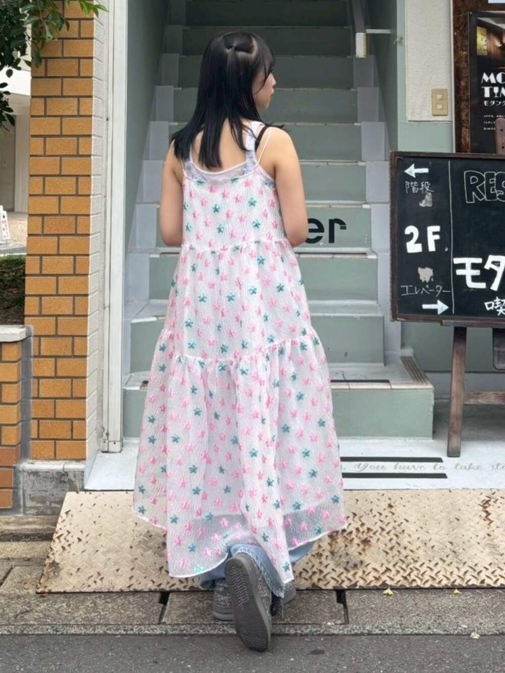 ピンク系のワンピース、ホワイト系のキャミソール、ブルー系のデニムパンツを着用したレディースの夏コーディネートの5枚目の写真