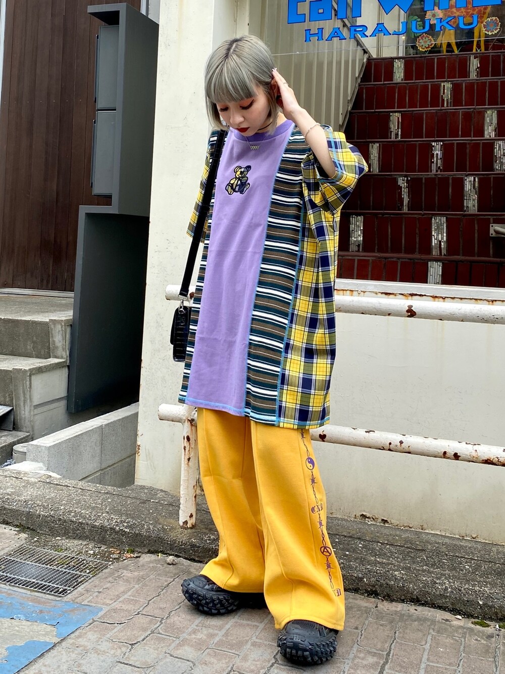 パープル系のTシャツ/カットソー、イエロー系のその他パンツ、ブラック系のショルダーバッグを着用したレディースの夏コーディネートの2枚目の写真