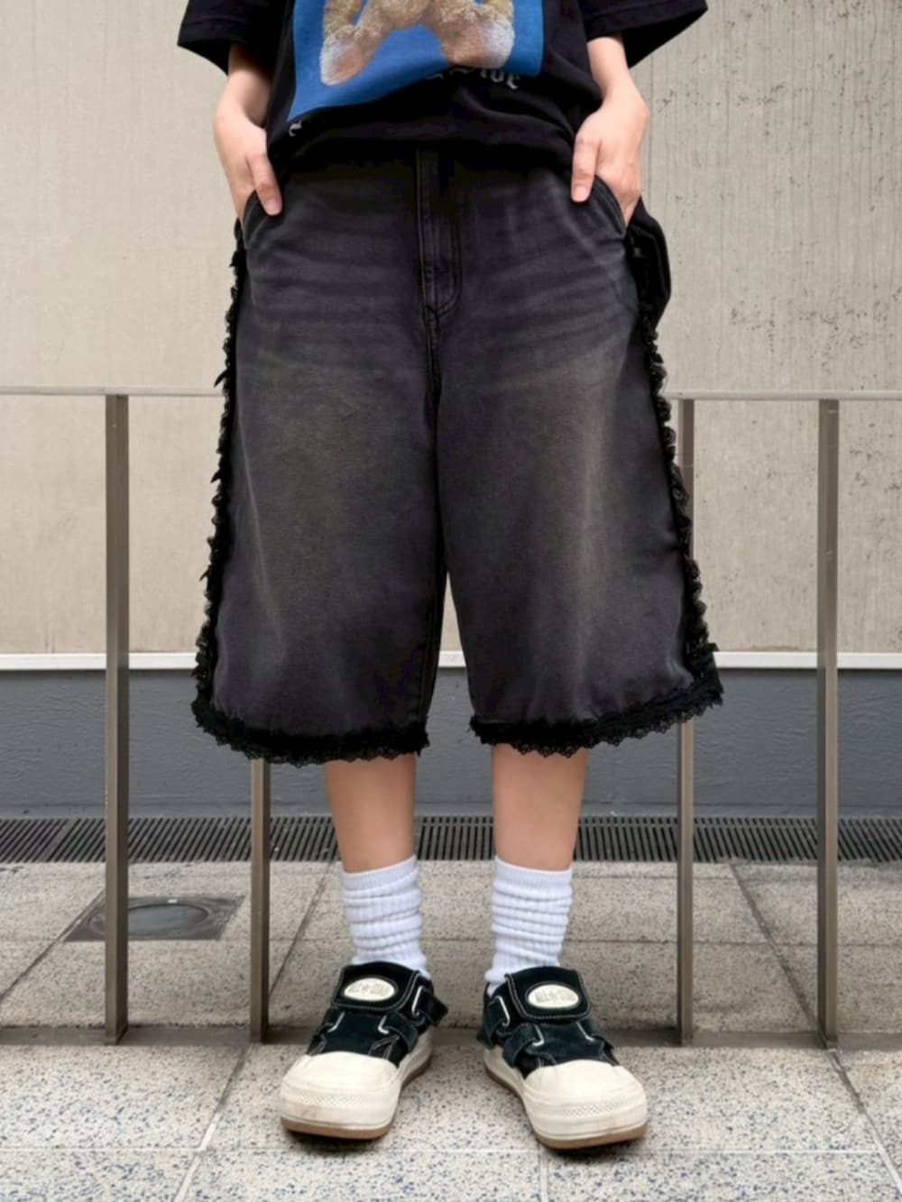 ブラック系のデニムパンツ、ブラック系のTシャツ/カットソー、シルバー系のベルトを着用したレディースの春コーディネートの5枚目の写真