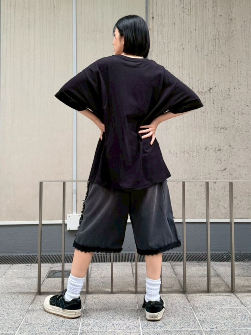 ブラック系のデニムパンツ、ブラック系のTシャツ/カットソー、シルバー系のベルトを着用したレディースの春コーディネートの3枚目の写真