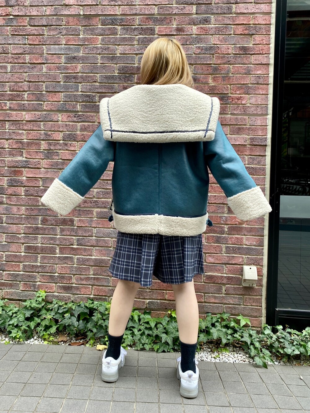 グレー系のスカート、ブルー系のその他アウターを着用したレディースの冬コーディネートの4枚目の写真