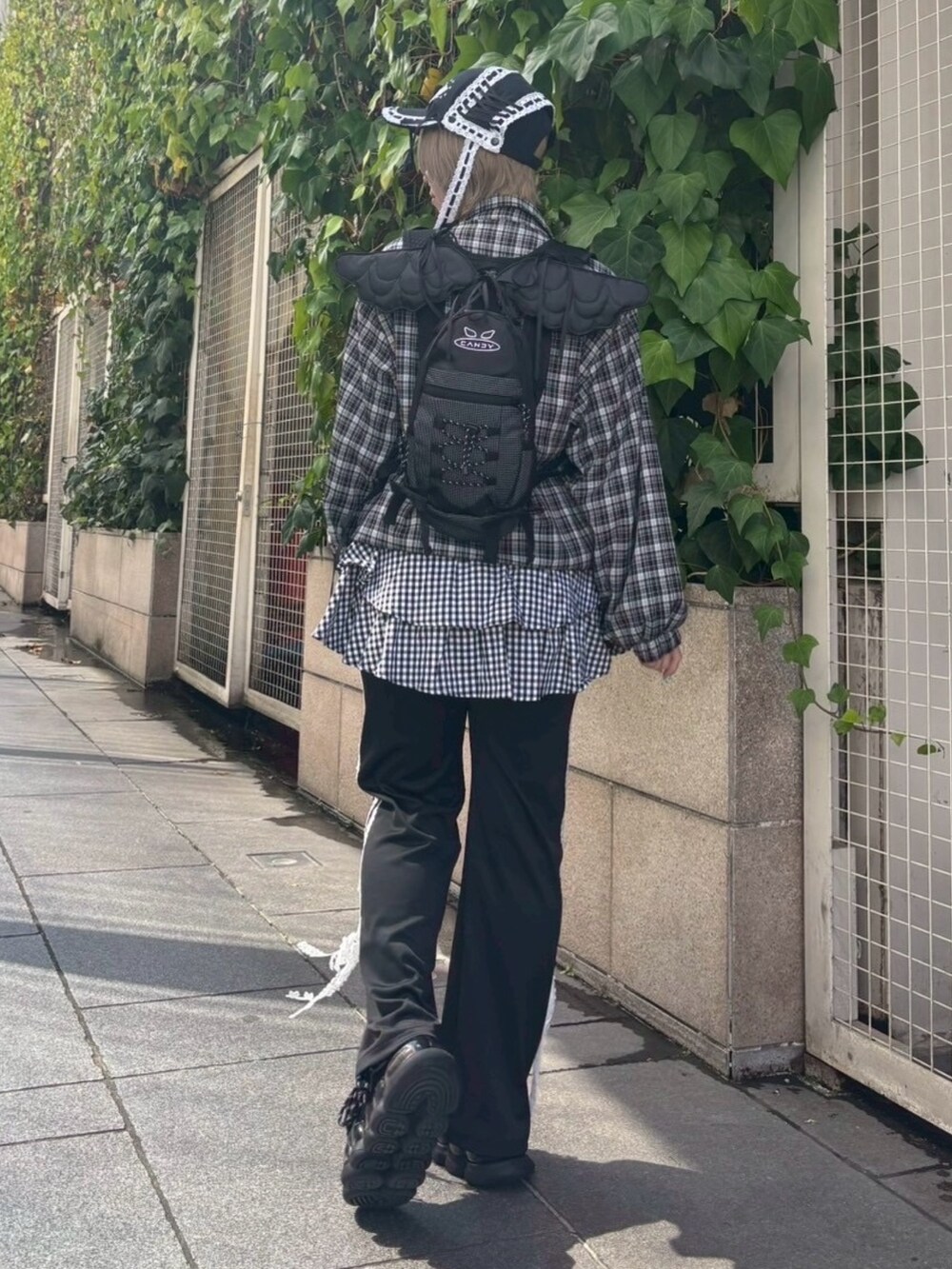 ブラック系のバックパック/リュック、ブラック系のその他パンツ、ブラック系のノーカラージャケットを着用したレディースの秋コーディネートの4枚目の写真