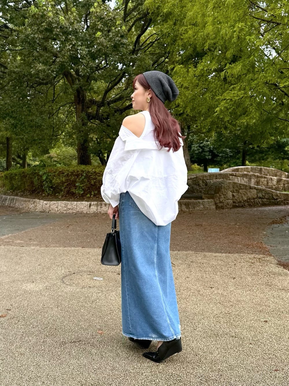 ホワイト系のシャツ/ブラウス、ブルー系のデニムスカート、ブラック系のパンプスを着用したレディースの秋コーディネートの3枚目の写真