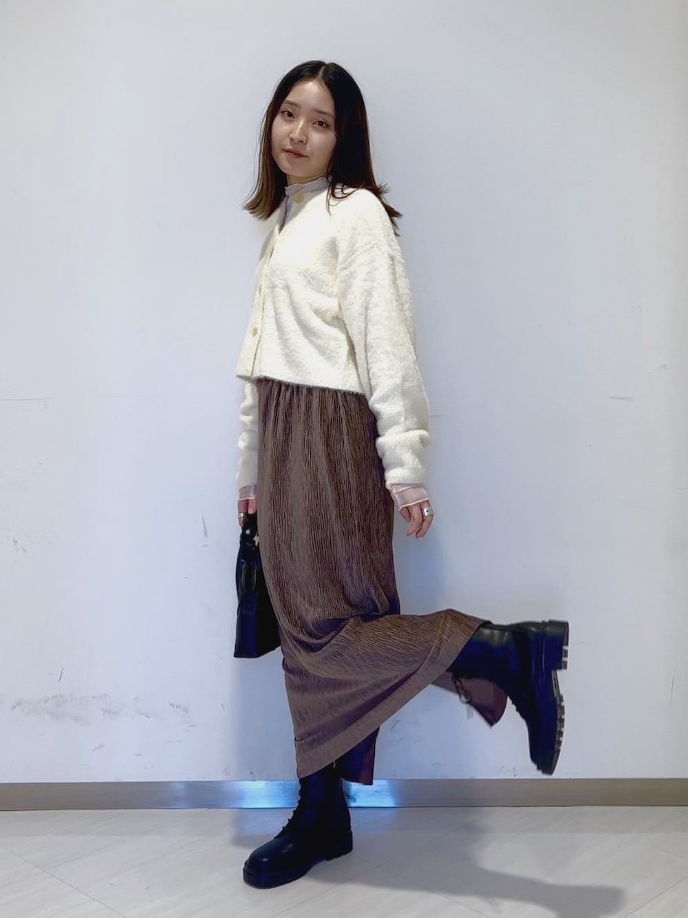 ホワイト系のTシャツ/カットソー、ホワイト系のカーディガン/ボレロ、ブラック系のショルダーバッグを着用したレディースの冬コーディネートの3枚目の写真