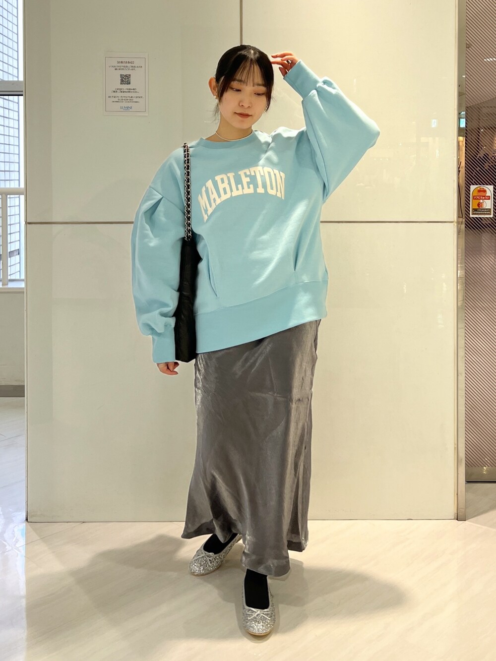 ブラック系のトートバッグ、ブラック系のスカート、ブルー系のスウェットを着用したレディースの冬コーディネートの3枚目の写真