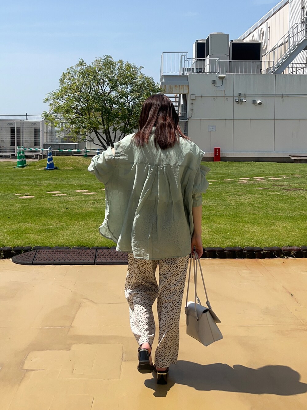 ブラック系のサンダル、ホワイト系のその他パンツ、グリーン系のシャツ/ブラウスを着用したレディースの春コーディネートの4枚目の写真