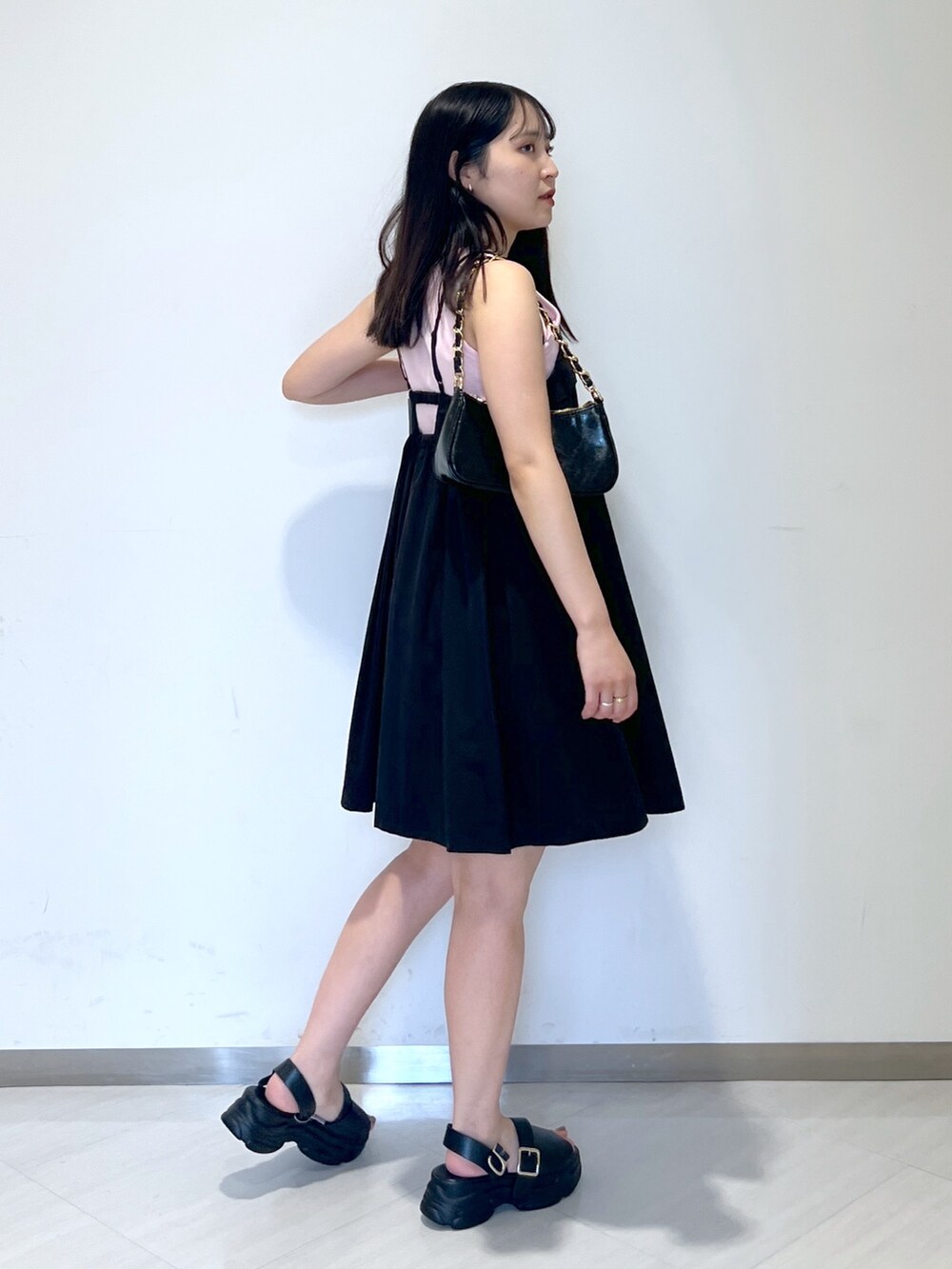 ピンク系のタンクトップ、ブラック系のワンピース、ブラック系のトートバッグを着用したレディースの夏コーディネートの3枚目の写真
