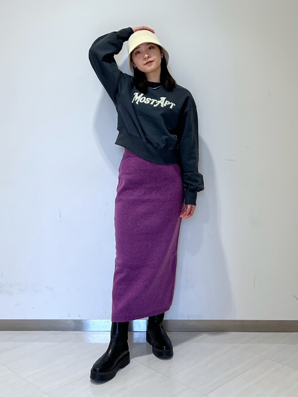 ブラック系のスウェット、パープル系のスカート、ベージュ系のハットを着用したレディースの冬コーディネートの3枚目の写真