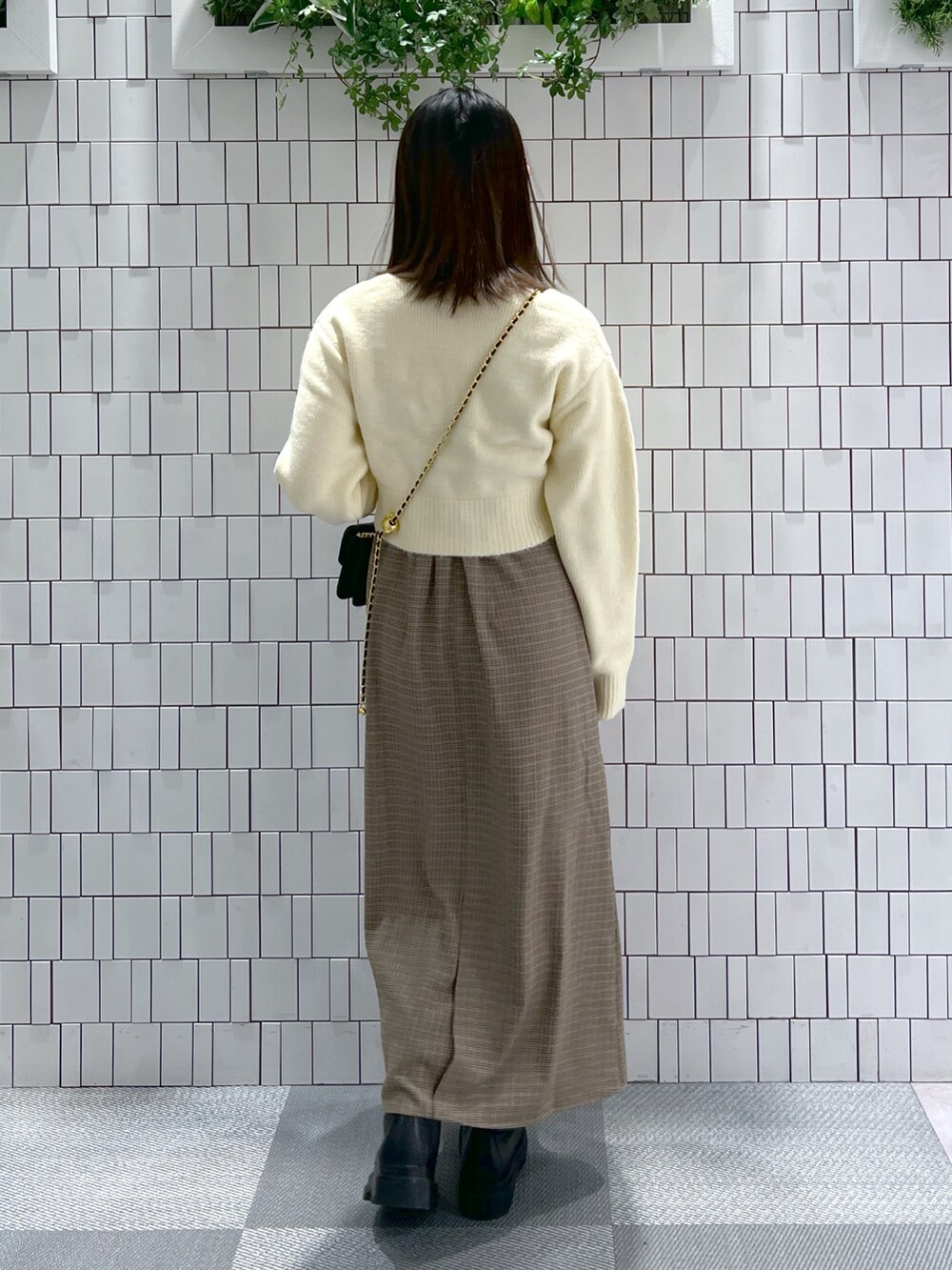 ホワイト系のニット/セーター、ホワイト系のTシャツ/カットソー、ブラウン系のワンピースを着用したレディースの冬コーディネートの5枚目の写真