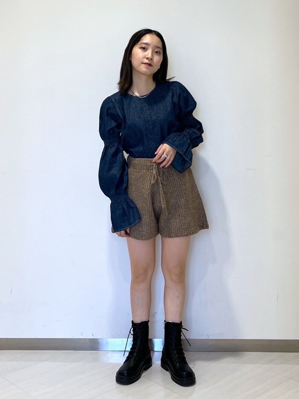 ブラウン系のその他パンツ、ブルー系のシャツ/ブラウス、ブラック系のブーツを着用したレディースの冬コーディネートの2枚目の写真