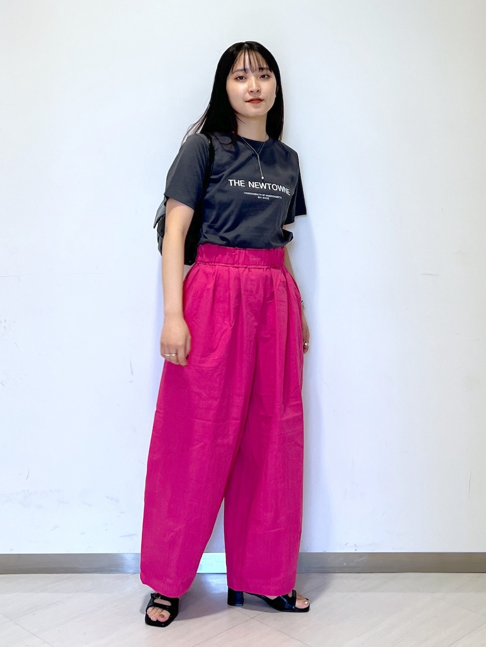 ピンク系のその他パンツ、ブラック系のTシャツ/カットソー、ブラック系のハンドバッグを着用したレディースの夏コーディネートの4枚目の写真