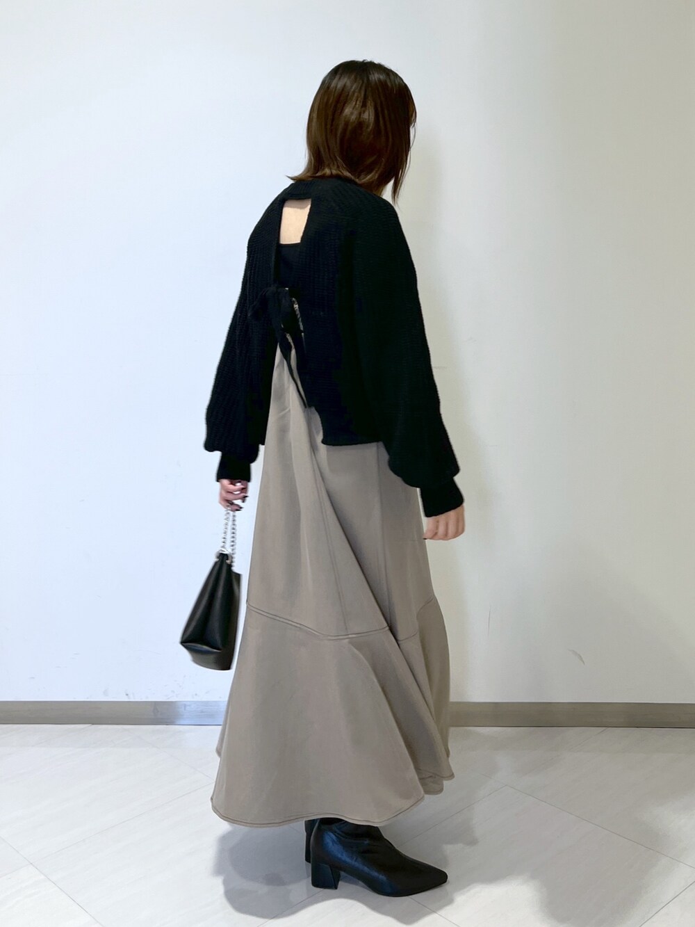 ブラック系のタンクトップ、ブラック系のニット/セーター、ブラウン系のワンピースを着用したレディースの秋コーディネートの5枚目の写真