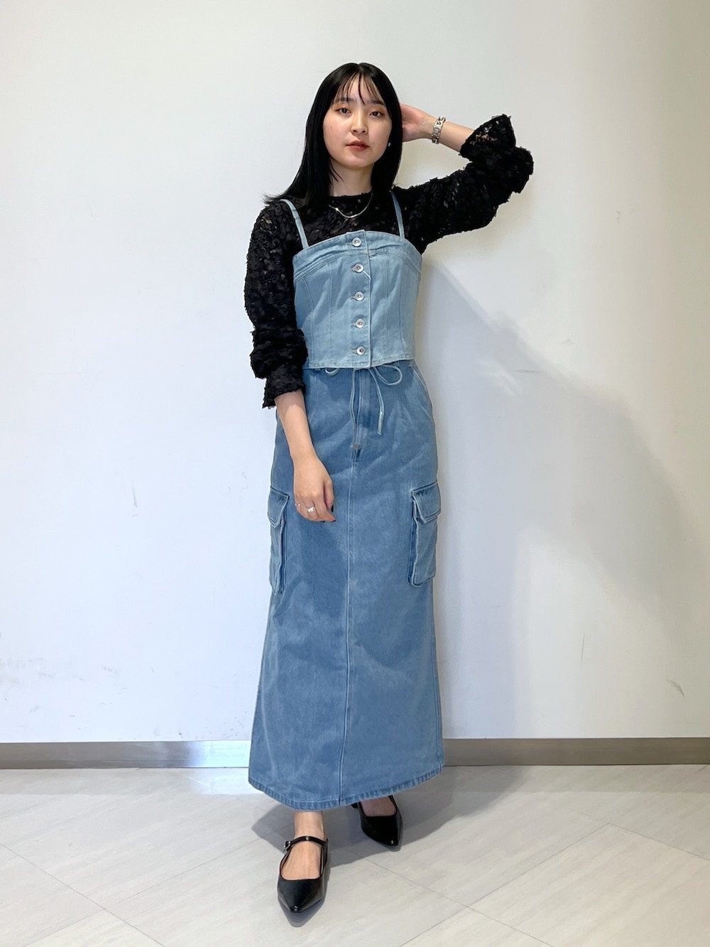 ブラック系のシャツ/ブラウス、ブルー系のベスト、ブルー系のデニムスカートを着用したレディースの冬コーディネートの2枚目の写真