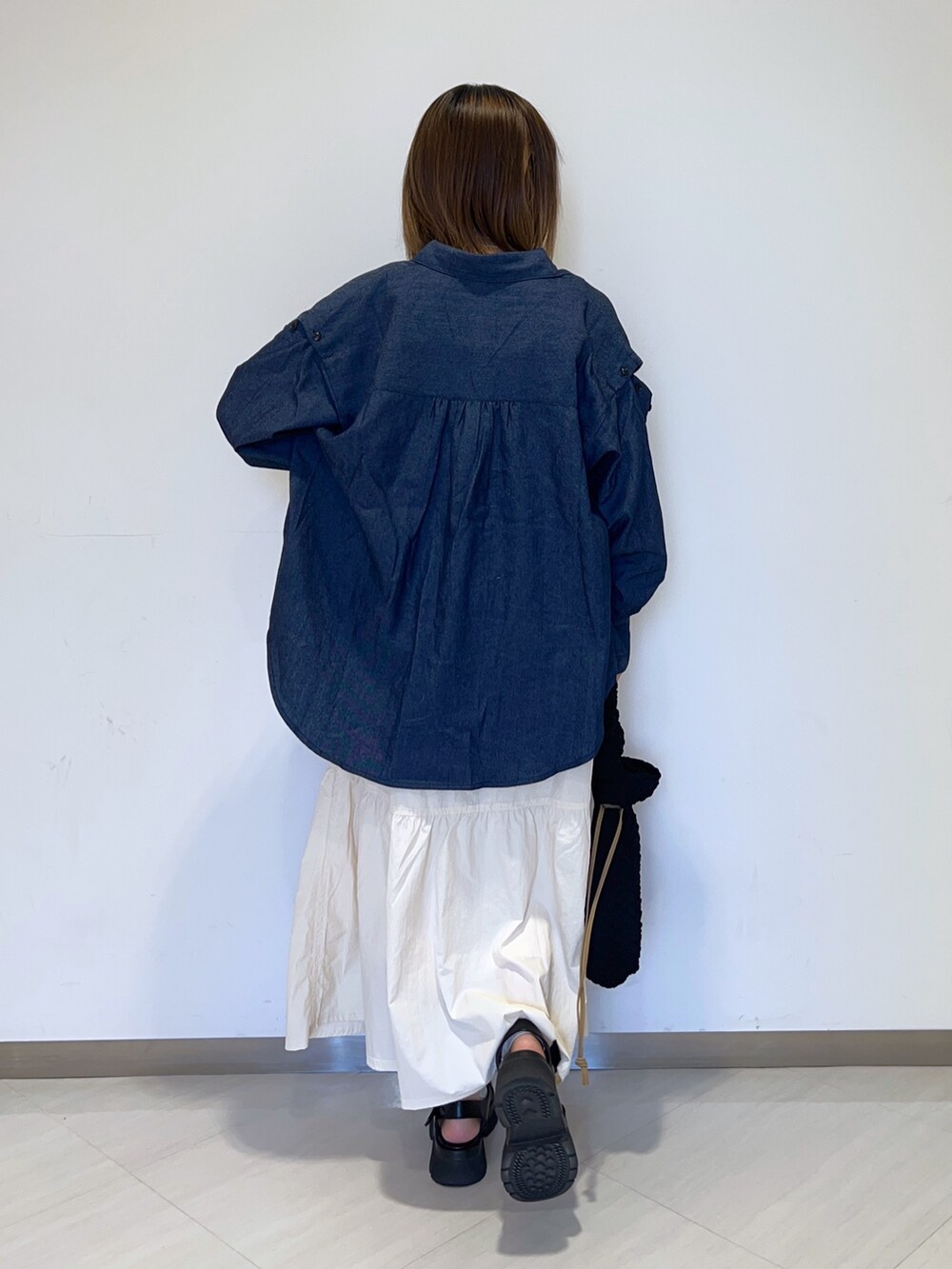 ホワイト系のタンクトップ、ブルー系のシャツ/ブラウス、ホワイト系のスカートを着用したレディースの秋コーディネートの6枚目の写真