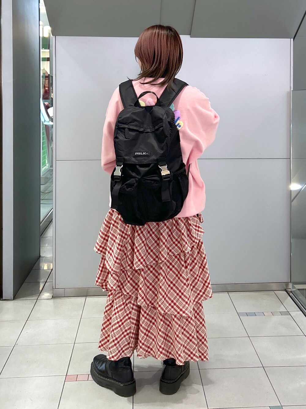 ブラック系のシャツ/ブラウス、レッド系のスカート、ブラック系のバックパック/リュックを着用したレディースの冬コーディネートの4枚目の写真