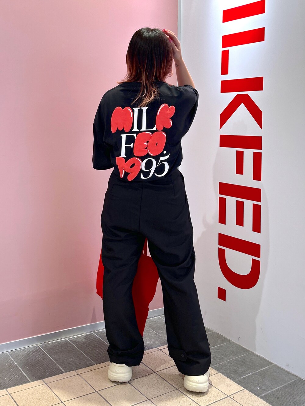 ブラック系のTシャツ/カットソー、レッド系のトートバッグ、ブラック系のその他パンツを着用したレディースの夏コーディネートの4枚目の写真