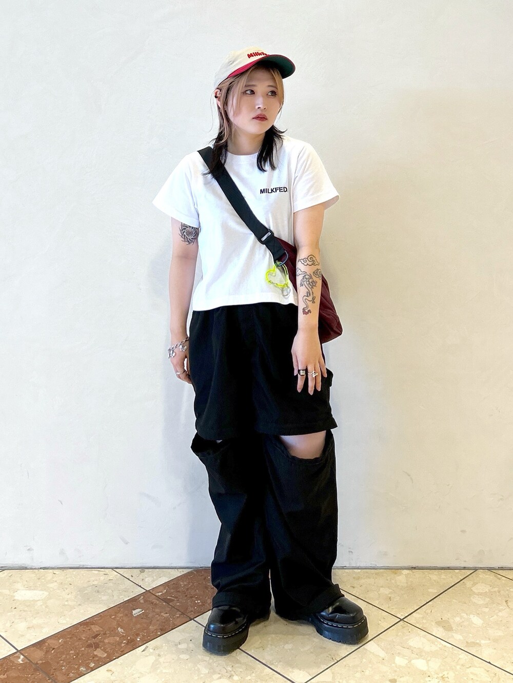 ブラック系のその他パンツ、レッド系のショルダーバッグ、ホワイト系のTシャツ/カットソーを着用したレディースの夏コーディネートの3枚目の写真