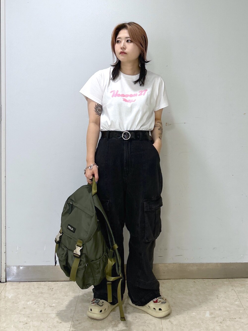 ベージュ系のサンダル、グリーン系のバックパック/リュック、ホワイト系のTシャツ/カットソーを着用したレディースの夏コーディネートの2枚目の写真