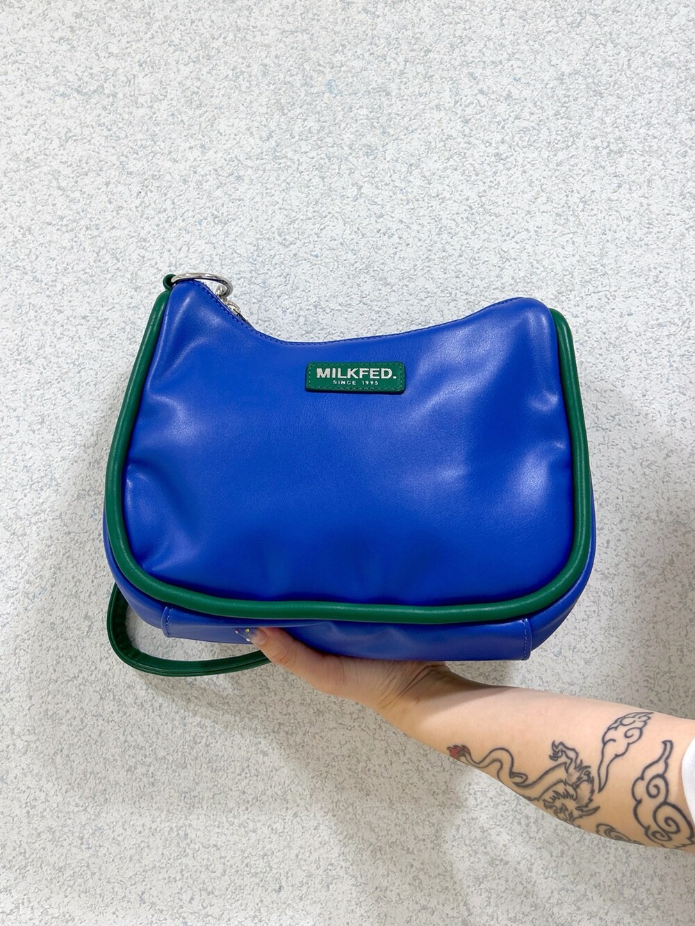 ホワイト系のTシャツ/カットソー、ブラック系のスカート、ブルー系のショルダーバッグを着用したレディースの夏コーディネートの6枚目の写真