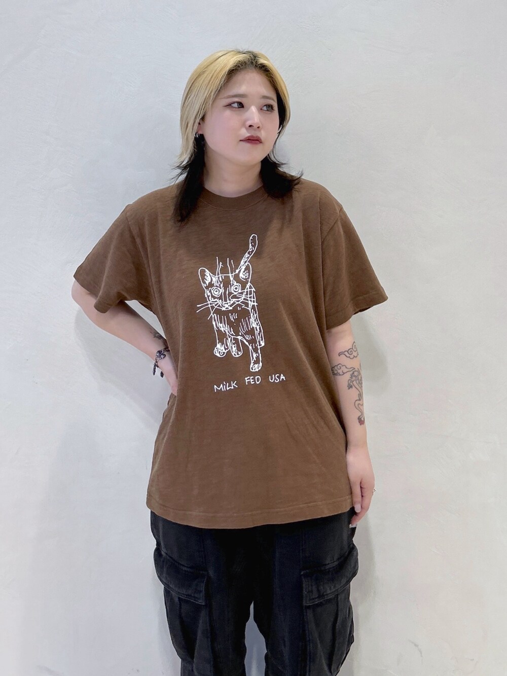 ブラウン系のTシャツ/カットソー、ブラック系のカーゴパンツ、レッド系のショルダーバッグを着用したレディースの春コーディネートの4枚目の写真