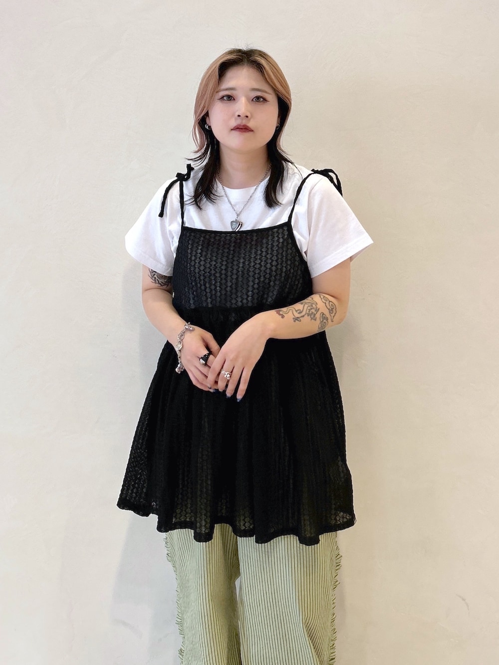 ブラック系のキャミソール、グリーン系のその他パンツ、ブラック系のブーツを着用したレディースの夏コーディネートの5枚目の写真