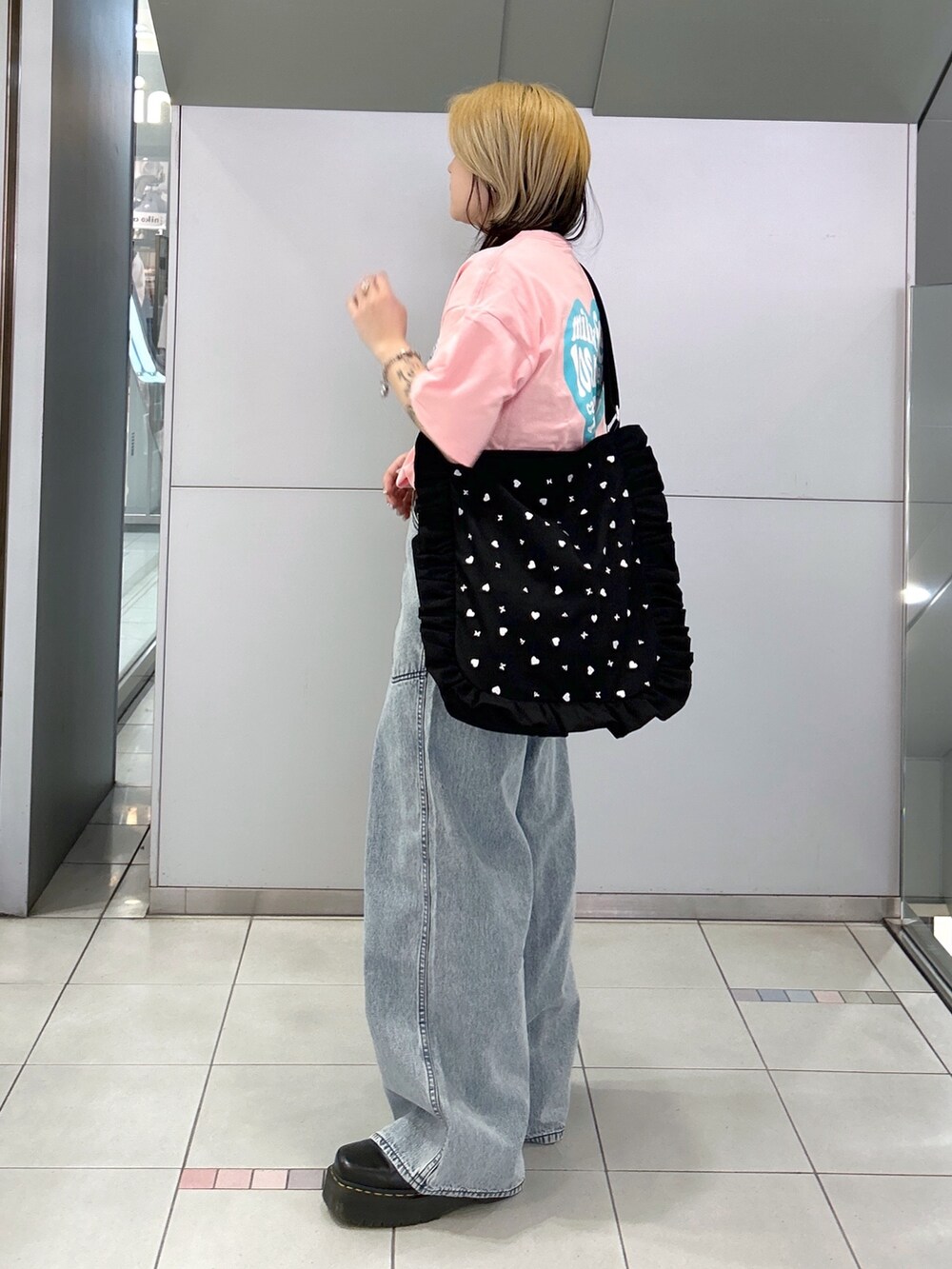 ピンク系のTシャツ/カットソー、ブルー系のデニムパンツ、ブラック系のショルダーバッグを着用したレディースの春コーディネートの3枚目の写真