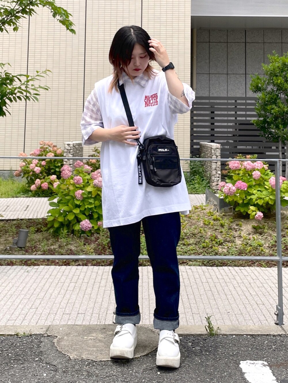 パープル系のシャツ/ブラウス、ホワイト系のTシャツ/カットソー、ブルー系のデニムパンツを着用したレディースの夏コーディネートの2枚目の写真