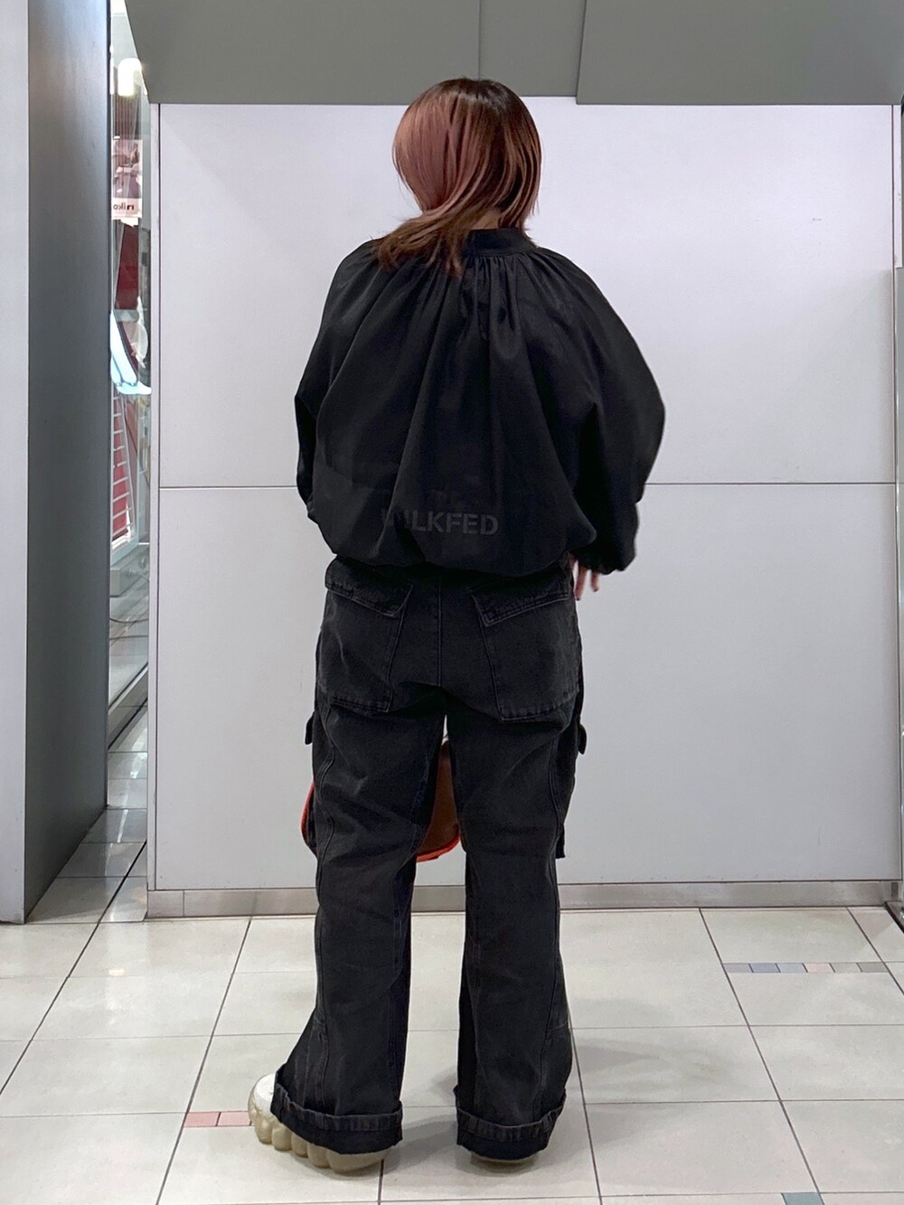 ブラック系のブルゾン、ブラック系のカーゴパンツ、ブラウン系のショルダーバッグを着用したレディースの春コーディネートの2枚目の写真