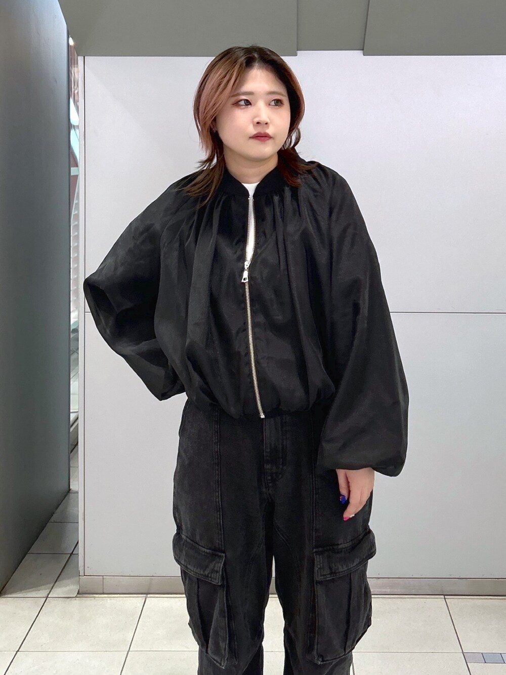 ブラック系のブルゾン、ブラック系のカーゴパンツ、ブラウン系のショルダーバッグを着用したレディースの春コーディネートの3枚目の写真