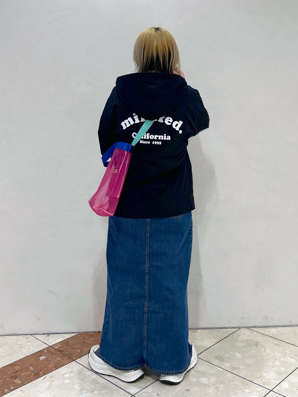 ブルー系のデニムスカート、ピンク系のショルダーバッグ、ホワイト系のTシャツ/カットソーを着用したレディースの春コーディネートの4枚目の写真