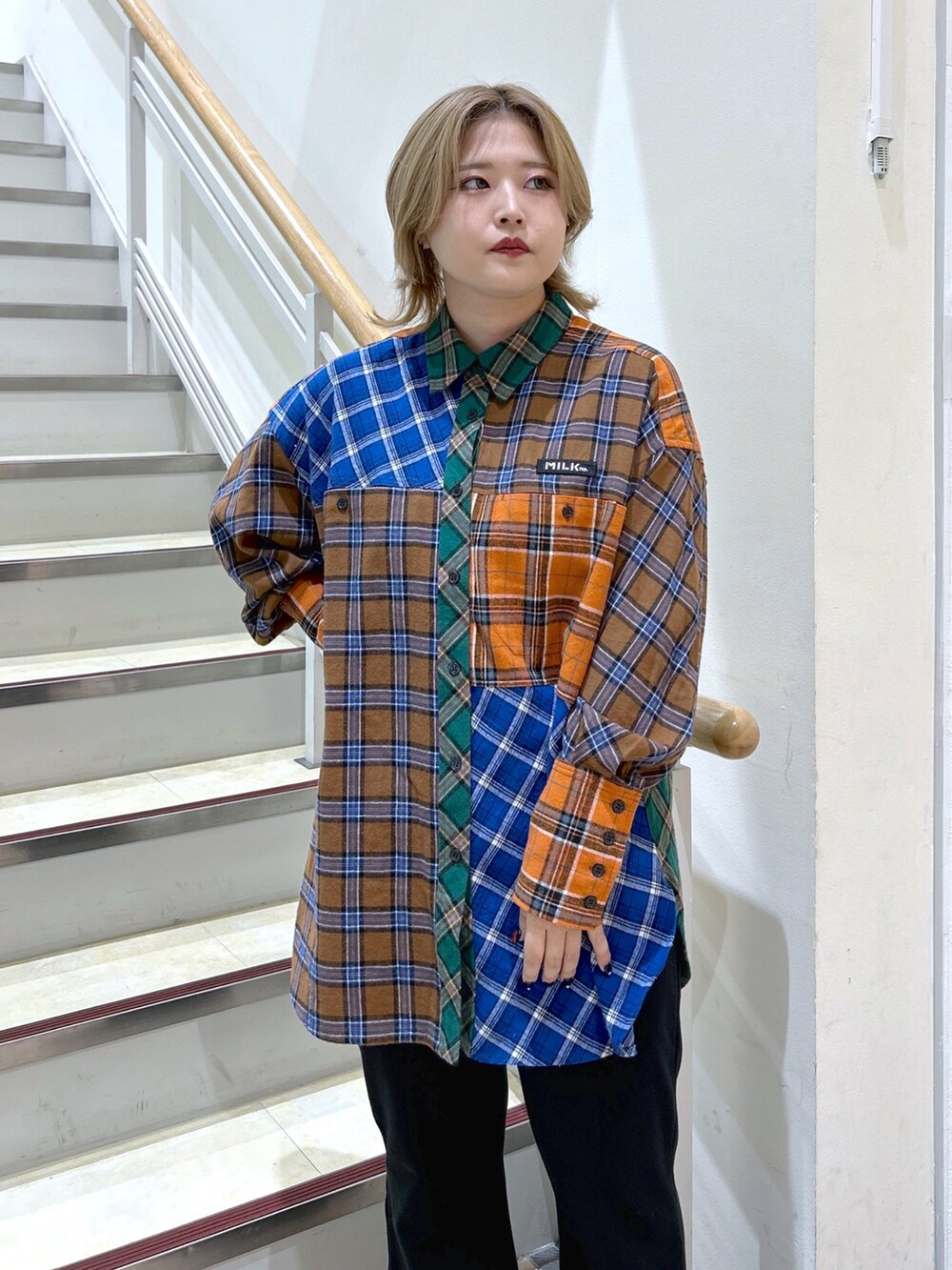 ブラウン系のシャツ/ブラウス、ブラウン系のボストンバッグ、ブラック系のスウェットパンツを着用したレディースの秋コーディネートの4枚目の写真