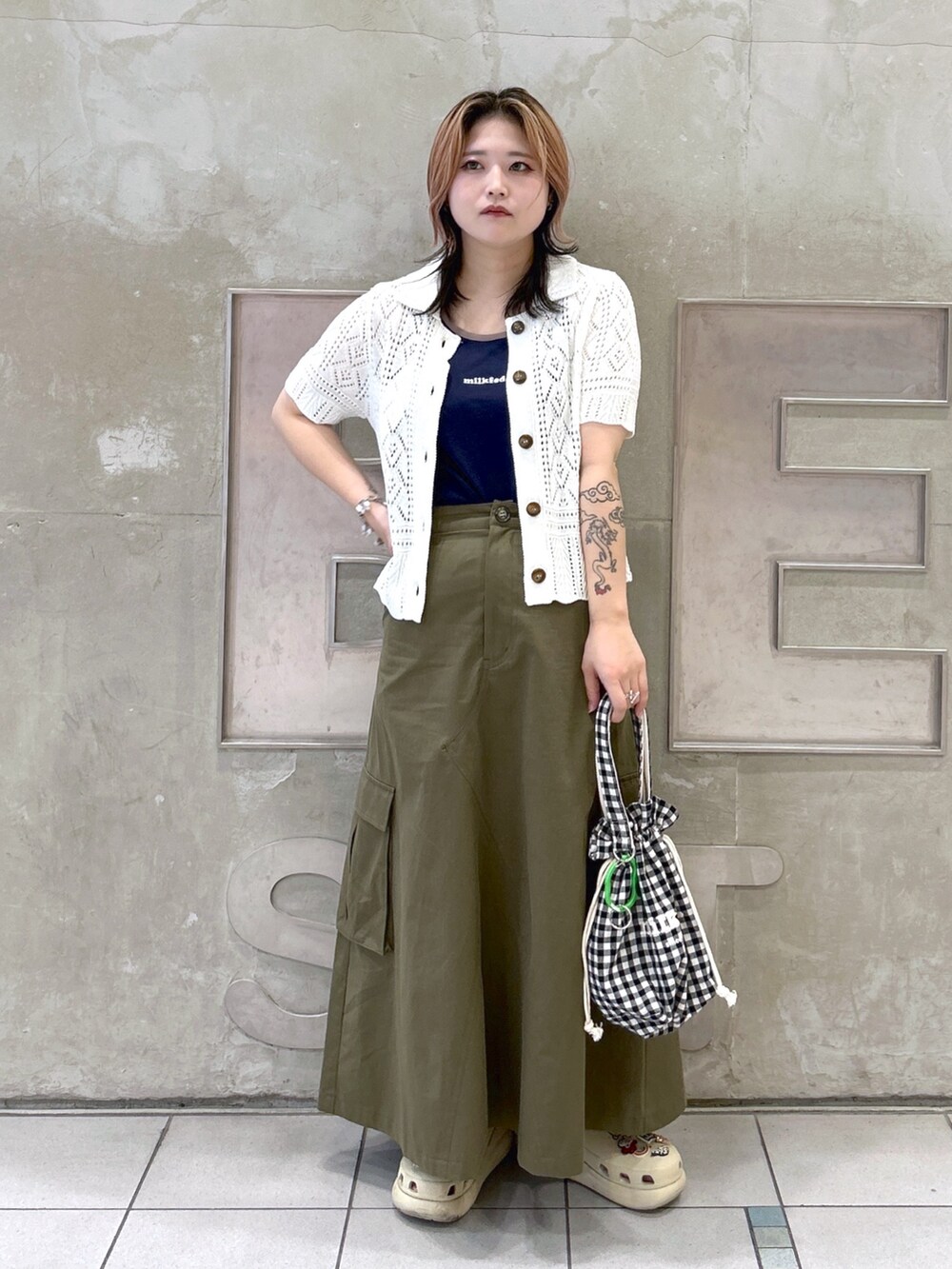 ブルー系のタンクトップ、ホワイト系のカーディガン/ボレロ、ベージュ系のサンダルを着用したレディースの夏コーディネートの2枚目の写真