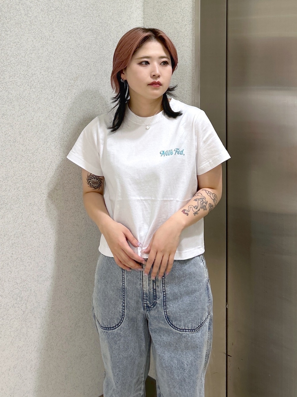 ブルー系のデニムパンツ、ピンク系のトートバッグ、ベージュ系のサンダルを着用したレディースの夏コーディネートの6枚目の写真