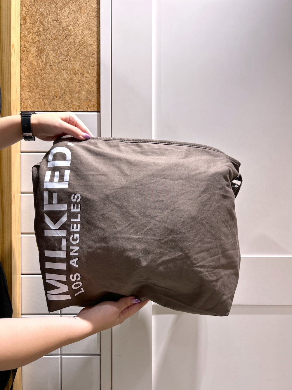 ブラック系のTシャツ/カットソー、ブラウン系のショルダーバッグ、レッド系のスカートを着用したレディースの秋コーディネートの4枚目の写真