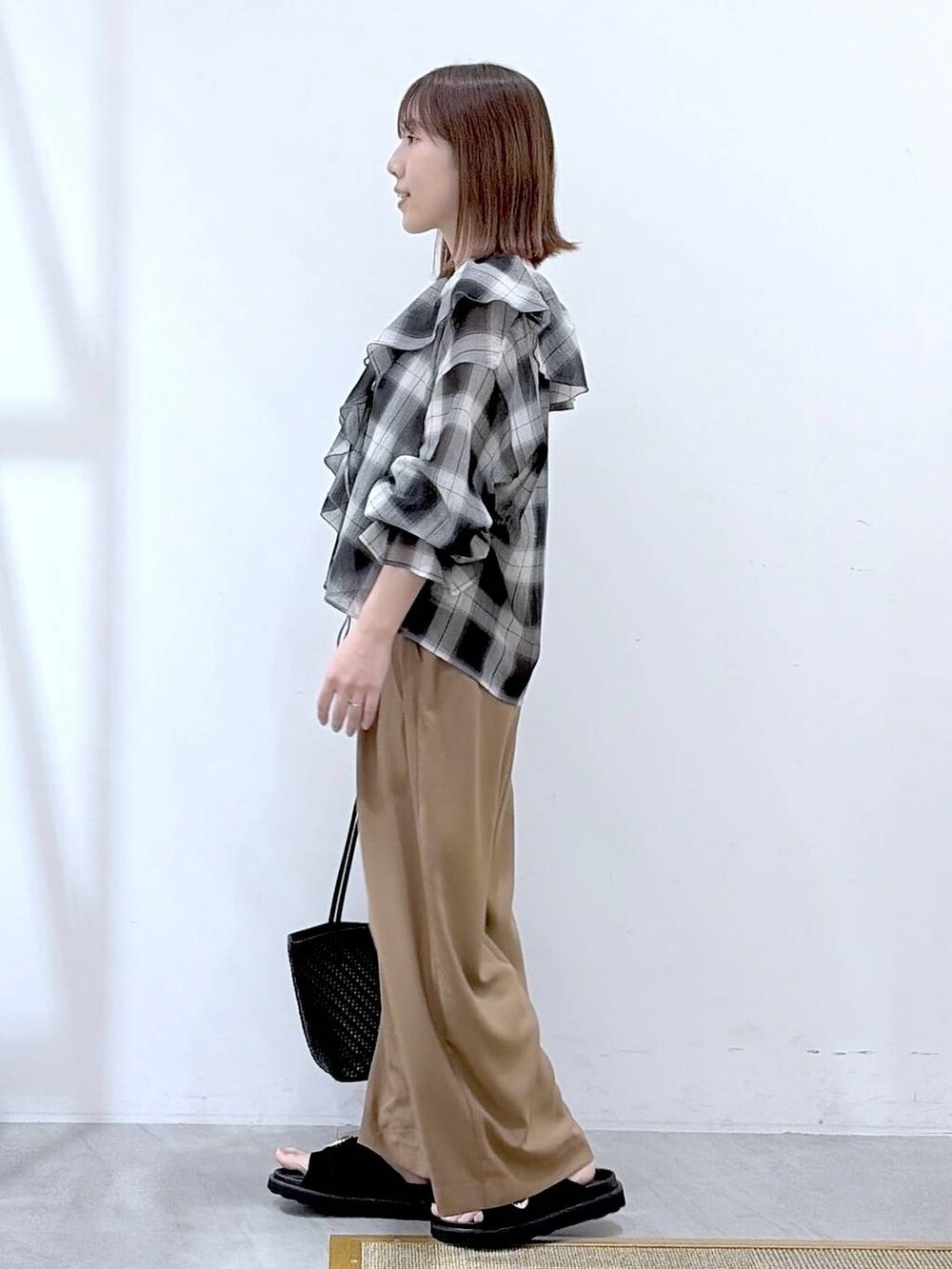 ブラック系のシャツ/ブラウス、ブラック系のその他パンツ、ブラック系のトートバッグを着用したレディースの夏コーディネートの2枚目の写真