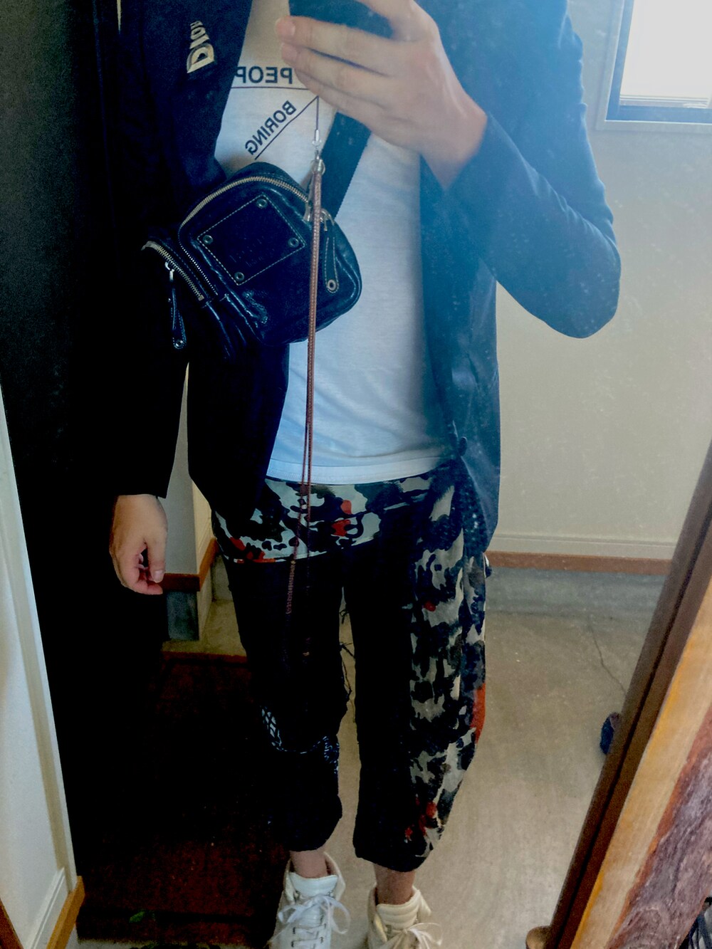 ホワイト系のスニーカー、ブラック系のテーラードジャケット、ホワイト系のTシャツ/カットソーを着用したメンズの秋コーディネートの2枚目の写真