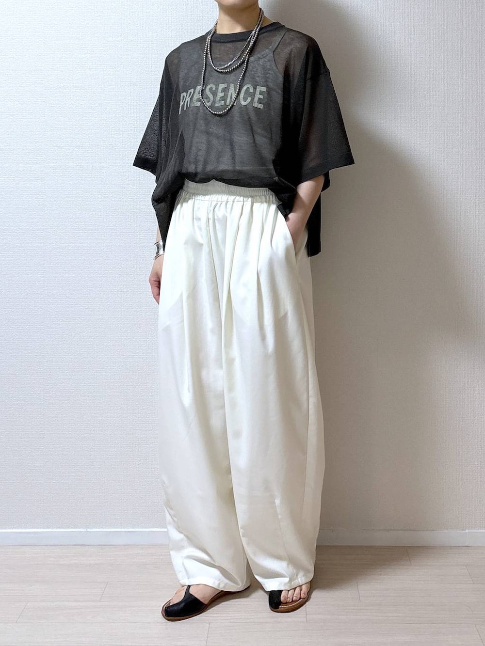 グレー系のニット/セーター、ホワイト系のその他パンツを着用したレディースの夏コーディネートの7枚目の写真