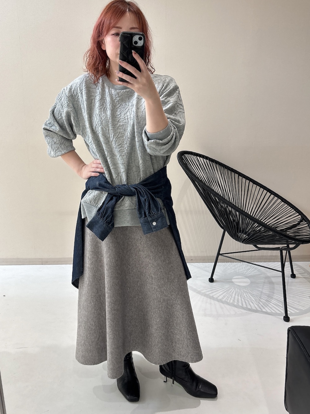 ブラック系のブーツ、グレー系のTシャツ/カットソー、グレー系のスカートを着用したレディースの冬コーディネートの4枚目の写真