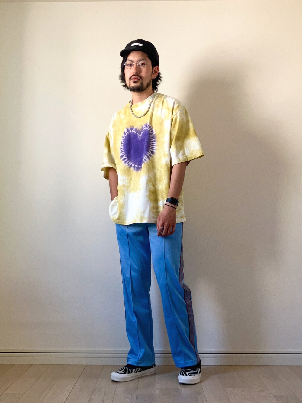 ブラック系のモッズコート、イエロー系のTシャツ/カットソー、ブルー系のデニムパンツを着用したメンズの春コーディネートの2枚目の写真