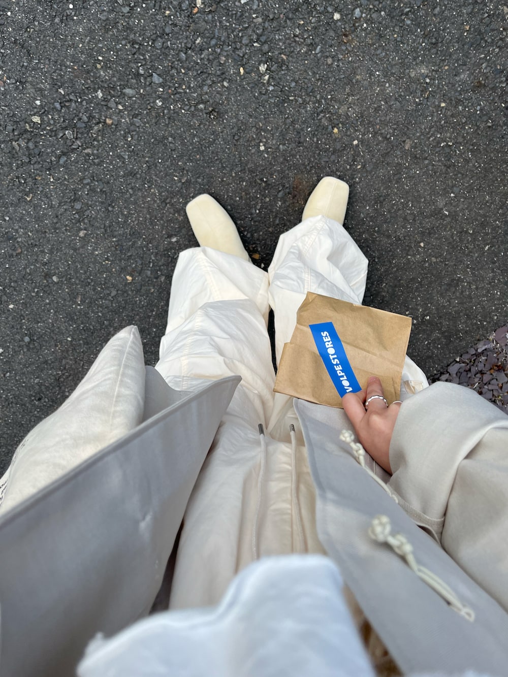 ホワイト系のノーカラージャケット、ホワイト系のカーゴパンツ、ホワイト系のブーツを着用したレディースの冬コーディネートの2枚目の写真