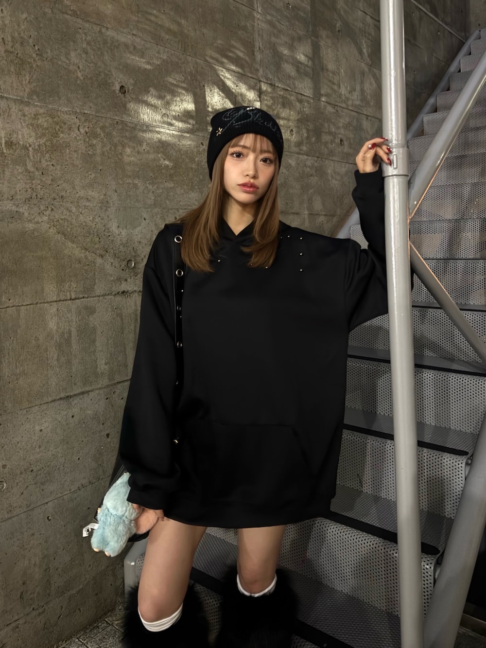 ブラック系のパーカー、ブラック系のレッグウォーマー、ブラック系のニットキャップ/ビーニーを着用したレディースの冬コーディネートの2枚目の写真
