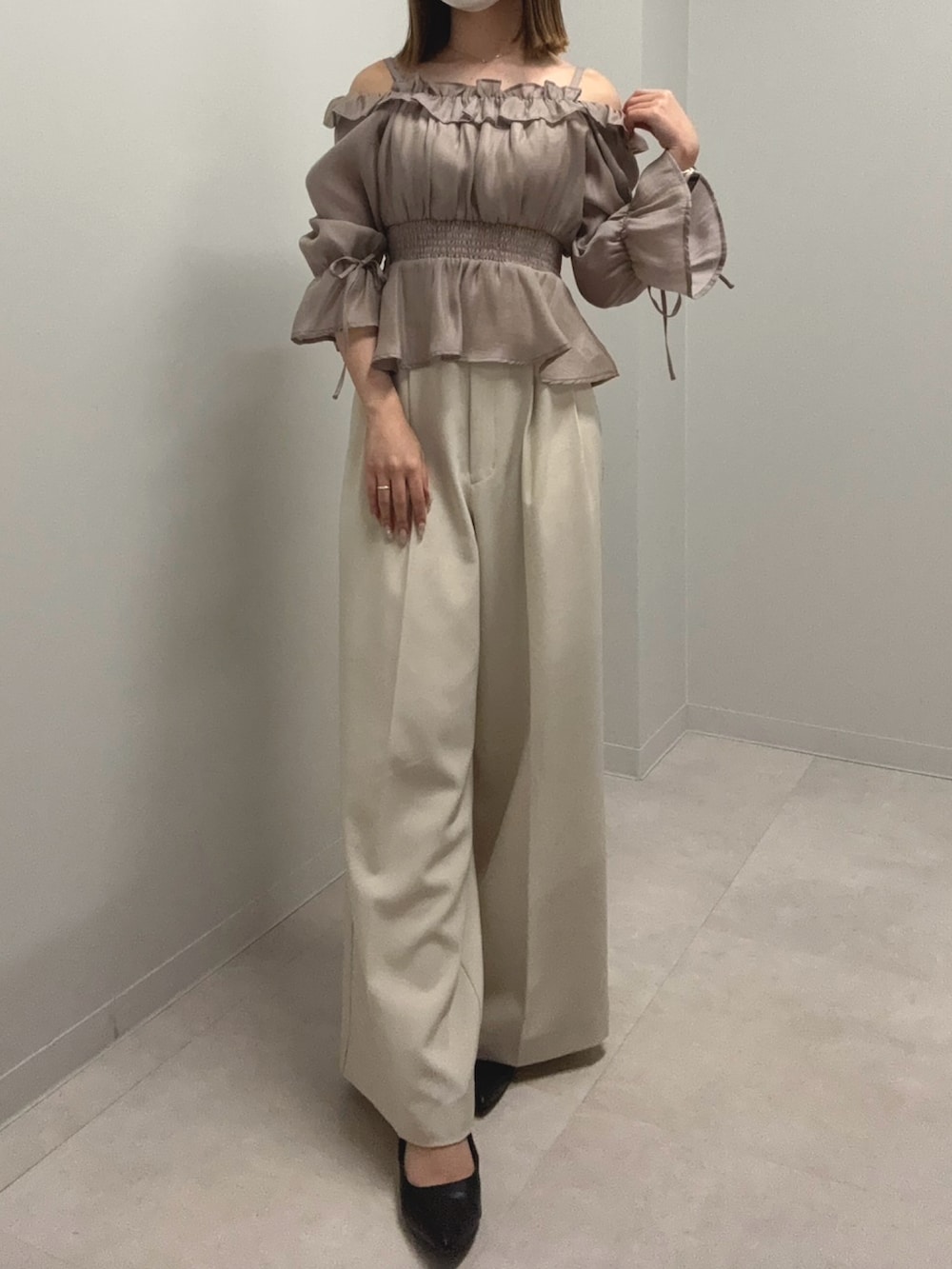 グレー系のシャツ/ブラウス、ベージュ系のその他パンツ、ブラック系のパンプスを着用したレディースの春コーディネートの2枚目の写真