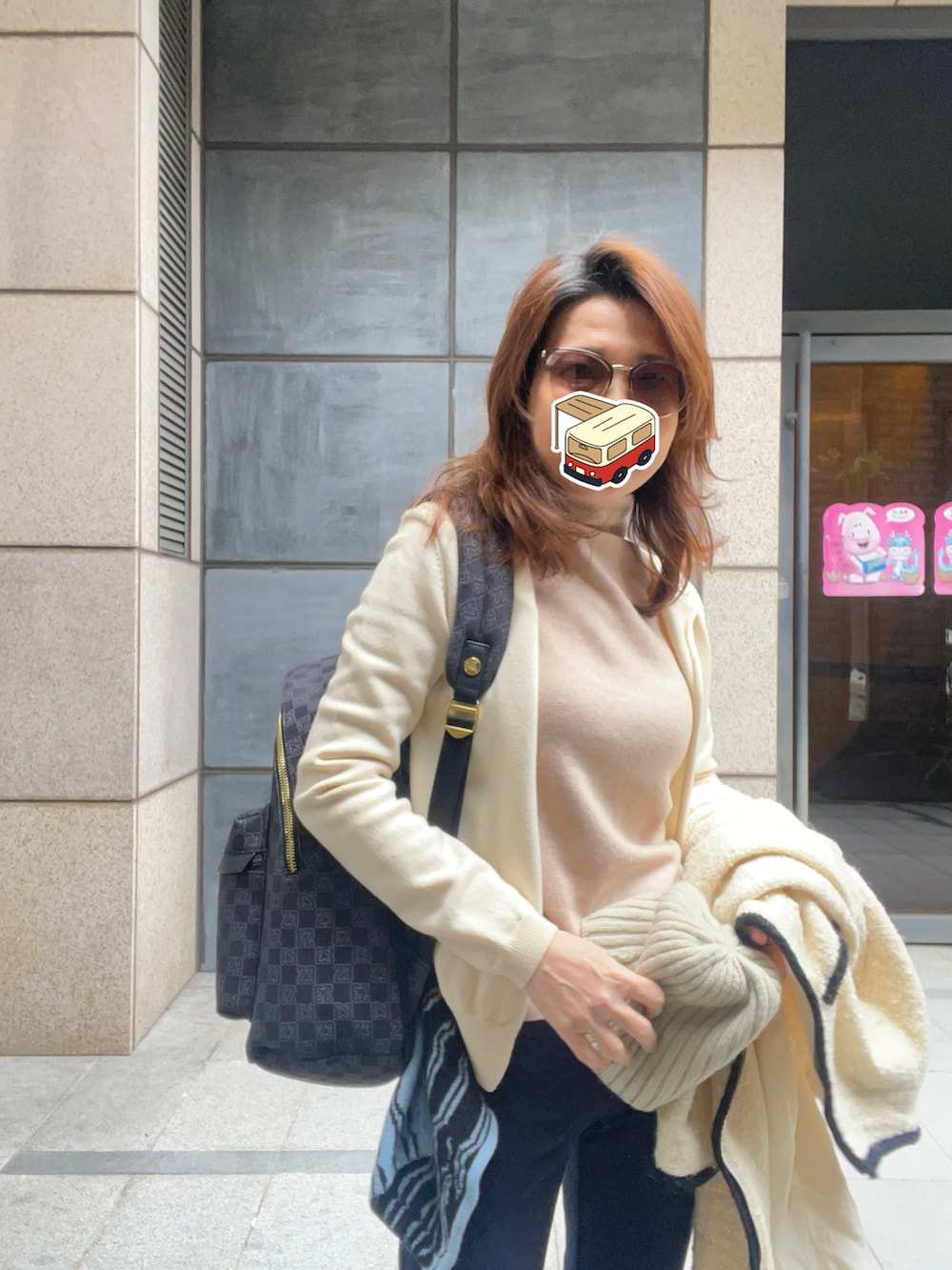 ベージュ系のニット/セーター、ブルー系のスラックス、ブラック系のブーツを着用したレディースの春コーディネートの4枚目の写真